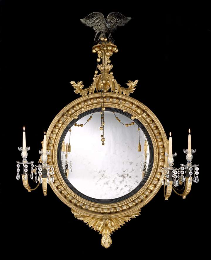 A REGENCY GILTWOOD CONVEX MIRROR ATTRIBUTED TO THOMAS FENTHAM